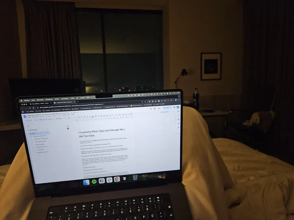 Laptop in bed with the article open