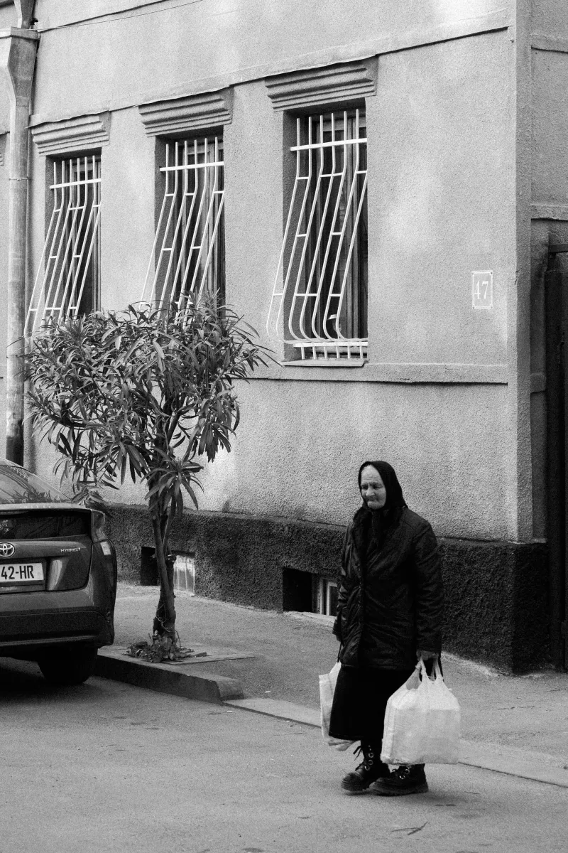 Woman with grocery bags on a quiet street