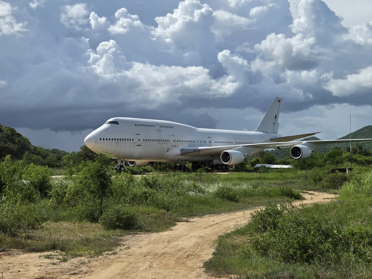 Abandoned Boeing 747 under storm clouds