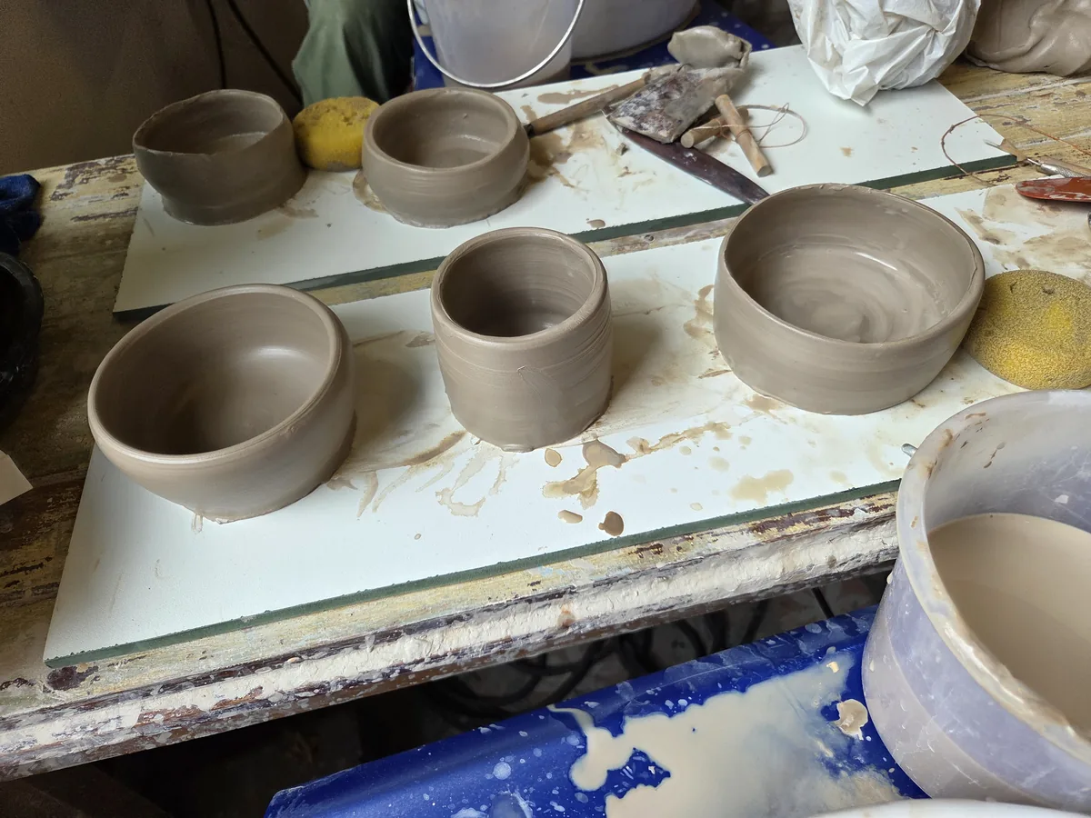 Freshly thrown clay bowls on the workshop table