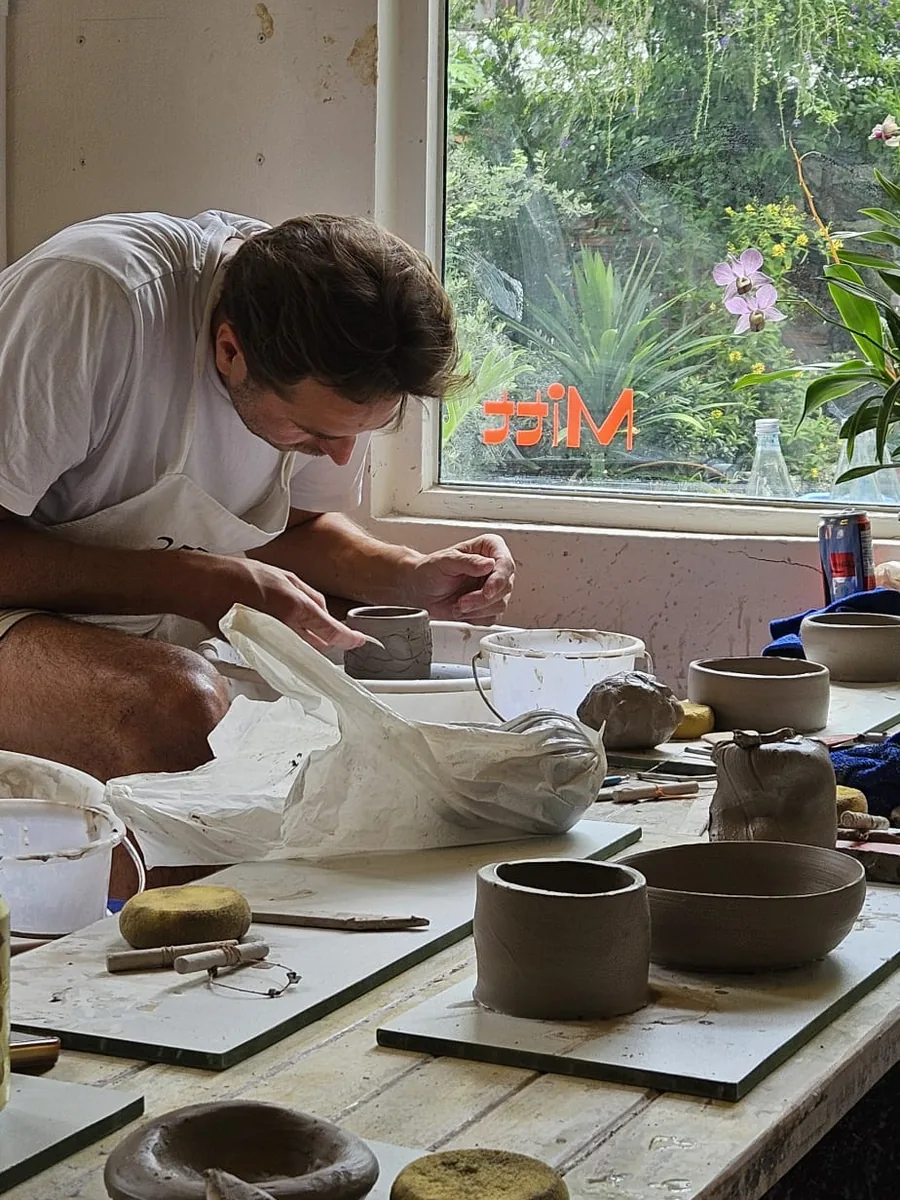 Daniel shaping a bowl at a pottery workshop in Chiang Mai